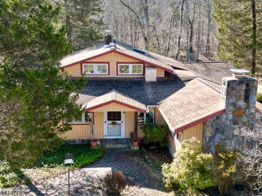 Looking for something unique? Do you love sunsets AND sunrises? You can have great views of both! This home started as a small hunting cabin in the 70's and grew along with its Owners over the past 50+ years into a sprawling home with soaring ceilings, a cheery sunroom, lots of light and so much character. Set on 12.55 gorgeous acres, 8 acres of woods in woodlands management and 3.55 acres of grassland, with an open 4 bay pole barn, the property is suitable for many uses including horses, hunting, homesteading and more. There are two bedrooms along with one full and one half bath in the main house, with two additional bedrooms and a full bath in a separate adjacent building steps away, but connected by a deck. This two story building with a loft offers three flexible rooms with high ceilings and lots of light, perfect for an in-law suite, a caretaker or a home business. Both bedrooms in the main house open to a rear deck for watching the sun rise with your morning coffee. The living room invites you to linger with lots of windows, a breezy beamed ceiling and a floor-to-ceiling fieldstone fireplace made from stone from the property. The long winding paved driveway curves around and up from the road to your private oasis in the country where flowering trees and perennials will soon welcome Spring. This truly unique home is a rare offering that suits many needs. About 10 minutes to route 80. Near to hiking, fishing and all that country living has to offer.