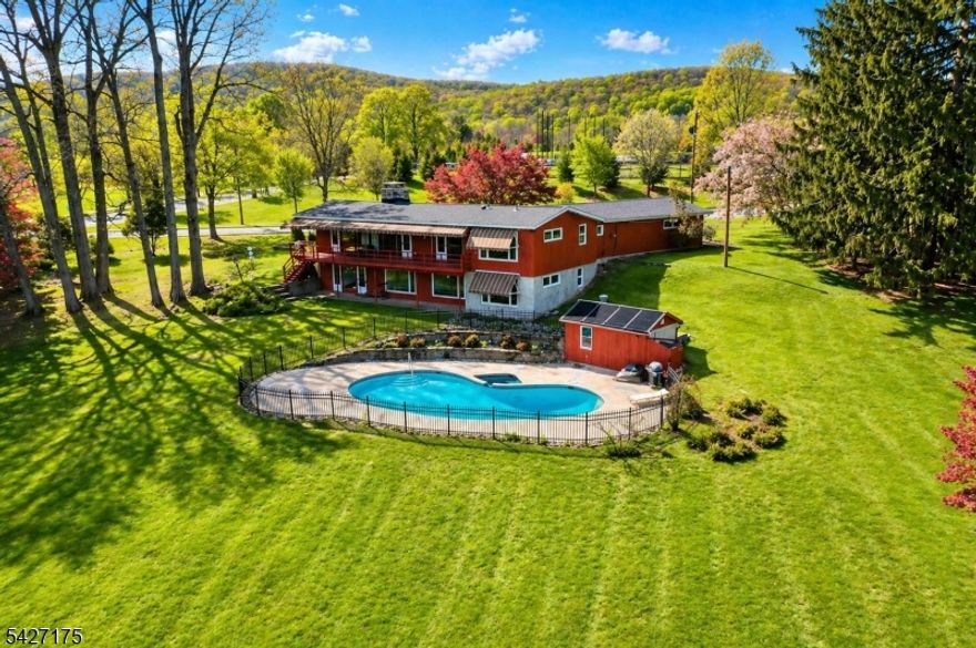 Welcome to your own private retreat in the heart of Hackettstown. Set on over 2 beautiful acres, this California-style ranch blends space, comfort, and resort-style living all just minutes from town. Step inside to soaring vaulted ceilings and a stunning see-through fireplace that creates a warm, open connection between the living and dining rooms. Natural light fills the home, with easy access to a full-length rear deck from the living room, dining room, and kitchen perfect for entertaining or simply enjoying the peaceful setting.Major updates have already been taken care of, including a brand-new roof and new heating and air conditioning system installed within the last 30 days, giving you peace of mind from day one. Outside is where this property truly shines. The expansive backyard features a heated inground pool, a pool house, and plenty of space to relax, host, or create your dream outdoor oasis. The home offers 3 bedrooms, 2.5 baths, a comfortable family room with a second fireplace, and a 3-car garage, providing flexibility for everyday living and storage.A rare opportunity to own a unique property with privacy, updates, and lifestyle all in a highly desirable Hackettstown location.