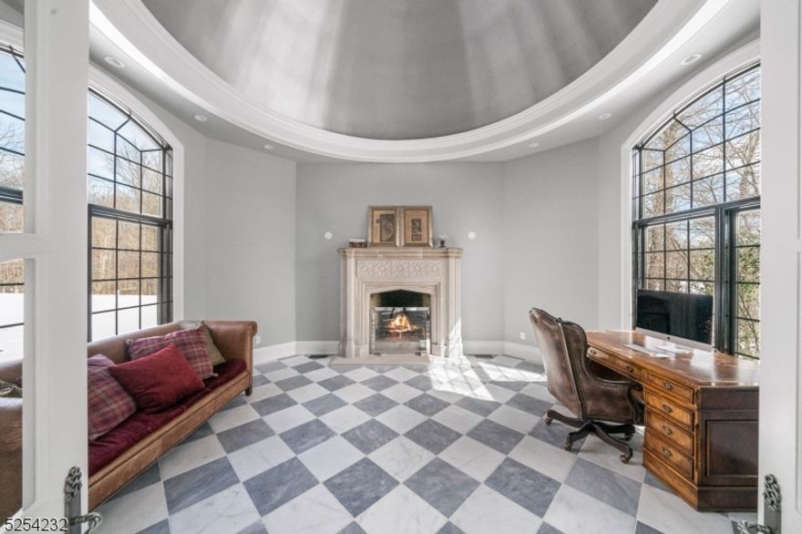 Welcome to a custom-built estate in coveted Mendham Township. This 5-bed, 5-full bath, 1-half bath residence sits on 5+ lush acres. Enter the grand foyer, greeted by natural light in the inviting living room. The heart of this home is the custom chef's kitchen, adjacent to a spacious dining room. The great room features a meticulously restored 18th-century French fireplace, flowing into the pool area for entertainment. Explore the left wing with an intimate loggia, stone fireplace, bespoke theater, gym, and private office. Upstairs, five en-suite bedrooms await, including a luxurious primary suite with a fireplace, spa-like bathroom, and sitting room. The private primary suite patio overlooks the landscaped backyard. Outside, the heated pool has hand-carved Neptune heads from France, a spa, and a fire pit for tranquil evenings. The partially finished basement offers storage or customization. Your dream estate awaits!