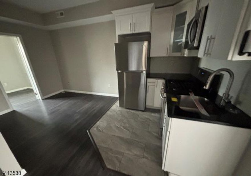 Great opportunity to own a well-maintained two-family home ideally located just minutes from the Lincoln Tunnel and public transportation, with convenient access to shopping, parks, and schools. Renovated in 2019, the property features updated kitchens and bathrooms throughout.Unit 1 offers 2 bedrooms plus a third bedroom/office, a spacious living room, kitchen, 1.5 baths, and sliding door access to the backyard. Unit 2 features 2 bedrooms and 1 full bath on the second floor. The home also includes a full unfinished basement with separate utilities for each unit, laundry area, and ample storage space. Property sold as-is, Purchaser responsible for CO.