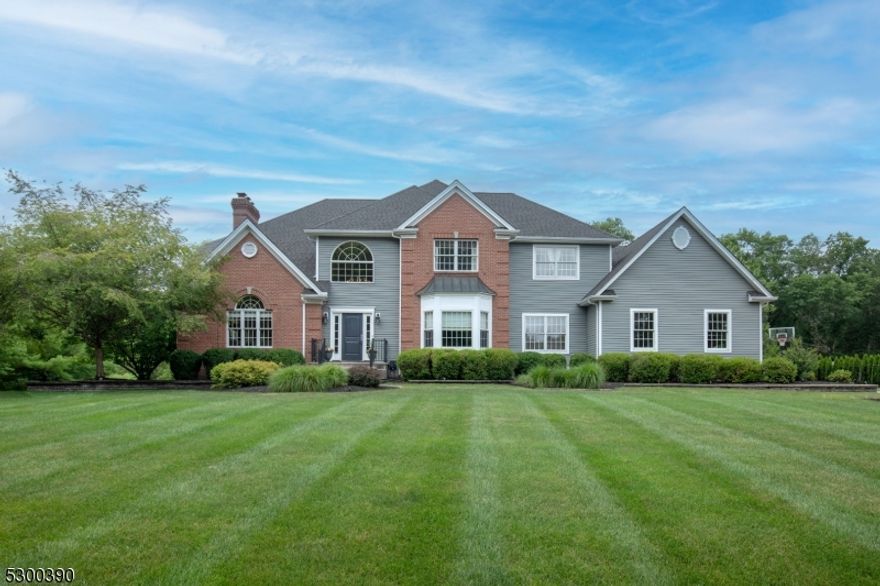 Welcome to your dream home in the serene cul-de-sac of Bedminster! This exquisite move in ready 4-bedroom, 3.5-bathroom residence showcases meticulous craftsmanship with oversized moldings, extensive trim work, and gleaming hardwood floors throughout much of the home.The heart of the home is the two-story family room, featuring a gas fireplace with intricate floor-to-ceiling millwork. Adjacent to this is a cozy living room with a wood burning fireplace, perfect for intimate gatherings. While the recently refreshed eat-in kitchen, featuring a center island, high end stainless steel appliances and a wet bar, are perfect for culinary enthusiasts and entertaining guests. A conservatory, bathed in natural light and surrounded by windows, provides stunning views of the private backyard, complete with an inground pool, a separate hot tub, cool decking, and a pergola for sun protection.  The large dining room is ideal for hosting dinner parties, while the first-floor office, mudroom, and laundry provide added convenience.The primary suite is a luxurious retreat with its own gas fireplace, offering warmth and comfort. Three additional bedrooms share a well-appointed hall bathroom. The finished basement is designed for entertainment and relaxation, featuring a recreation room with custom built-ins surrounding a gas fireplace, a kitchenette, game room, gym, full bathroom, and ample storage. A staircase provides easy access to the three-car garage.  New roof in August of 2022.