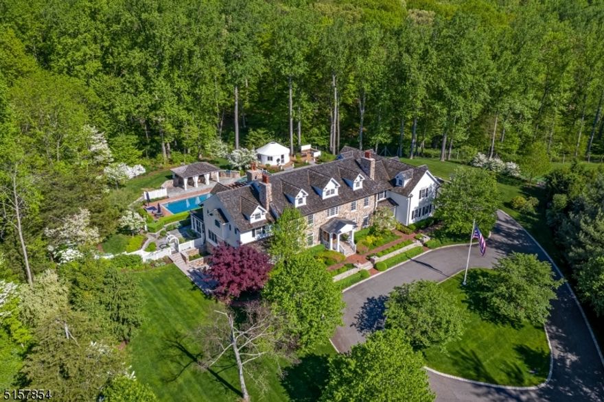 This stunning Mendham showpiece comprises 5.4 breathtaking acres and a magnificent 9000-sq ft custom designer residence. Sophistication and style are defined by the artfully executed millwork, paneling, moldings, tray ceilings, hardwood floors with inlay, 6 fireplaces, French doors & an extraordinary shot-gun foyer. Thoughtful architectural details abound in the carefully designed & crafted home. The stylish Kitchen was configured for cooking & entertaining. The primary suite with tray ceiling has a sitting room, two fireplaces, a luxurious bath, and private veranda overlooking the rear yard. All bedrooms are en-suite with walk-in closets. The lower level provides a media room with a wine cellar, exercise room, game rooms with outdoor terrace, and half bath. The unsurpassed resort-style rear yard boasts bluestone and limestone patios, a salt-water pool, a covered veranda with fireplace, a covered dining terrace, yoga yurt, potting terrace, and a hot tub with seating area and firepit. Shopping, dining & recreational opportunities abound in the area as well as our excellent schools.