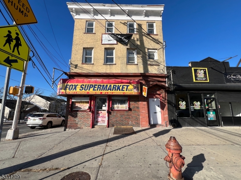 This versatile property offers a unique investment opportunity in Newark's thriving Springfield/Belmont neighborhood. The building features five units, including two ground-level commercial spaces currently operating as a grocery store and a convenience store, providing steady income potential. The residential component includes three well-maintained apartments: a spacious 3-bedroom, 1-bath unit, a comfortable 2-bedroom, 1-bath unit, and a studio apartment. Each residential unit boasts bright, airy living spaces with updated kitchens, creating an inviting and modern living environment. A finished basement completes the property.Strategically located near schools, parks, shopping, and dining options, the property is ideal for tenants seeking convenience and accessibility. Public transportation and major highways are easily accessible with public bus stops across the street, ensuring connectivity to downtown Newark and surrounding areas. Whether you're looking to expand your portfolio or secure a property with diverse income streams, this location offers endless possibilities in a dynamic and growing community.