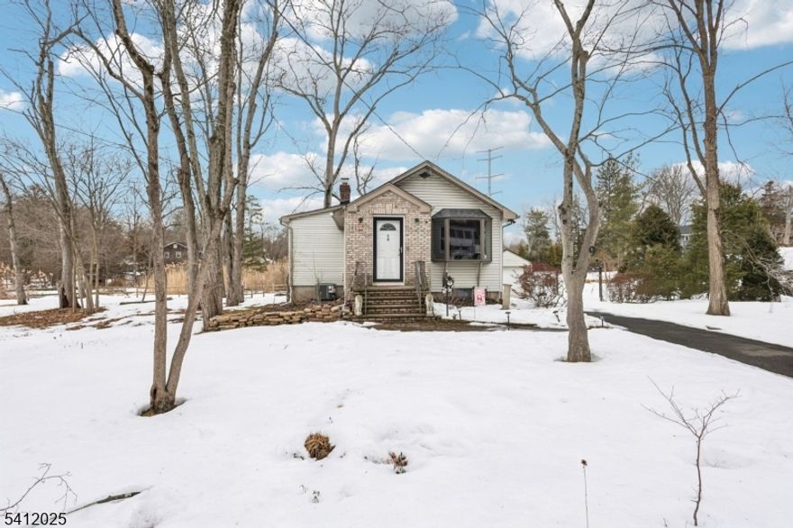 Welcome to this charming, sun-filled Ranch offering thoughtful updates and true move-in-ready convenience. Set on a spacious, private lot, this beautifully maintained home blends comfort, style, and future potential. Recent updates include a new roof, new HVAC (2025), new water heater (2025), fresh interior paint, an updated bath, and a renovated kitchen featuring granite counters. Designed for easy one-level living, with room to expand in the future, the home welcomes you into a spacious living room filled with an abundance of natural light flanked by a charming bay window and built-in bookshelves. The updated kitchen offers granite counters, plenty of prep space, and an island with seating and storage, while a skylight enhances the space with natural sunlight. The adjoining dining area features sliding glass doors that open to a spacious wood deck, perfect for entertaining or relaxing. Two comfortable bedrooms (one ideal for a home office) and a tastefully renovated full bath complete the main level. The finished lower level expands the living space with a large recreation room featuring a cozy wood-burning stove ideal for relaxing, working from home, or a personal gym. Additional highlights include an exterior basement entrance, generous storage, a large laundry room, a detached one-car garage, and a multi-car driveway. Conveniently located close to NJ Transit trains, highly rated schools, shopping, and restaurants. A rare opportunity in this highly desirable town!