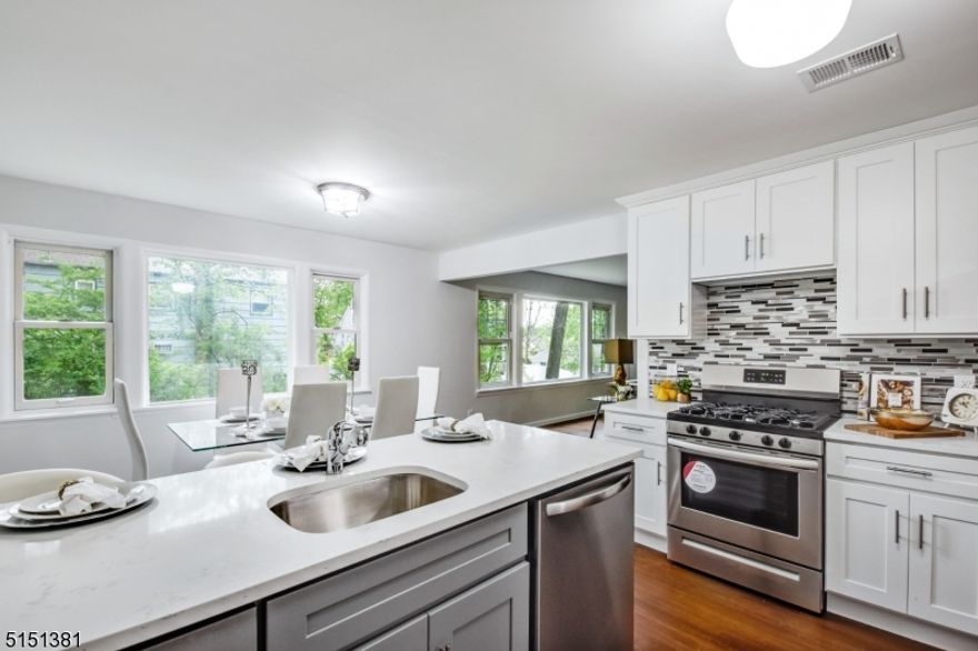 NOTHING TO DO BUT MOVE IN! Be the FIRST to move into this CUSTOM DESIGNED & NEWLY RENOVATED RANCH! This beautiful ranch is turn key move in ready, boasting modern updates throughout. Plenty of space with 3 oversized bedrooms and 3 full bathrooms & full finished basement. Upon arriving at the home you will see the large outdoor deck perfect for entertaining. The open concept floor plan is complete with brand new chef's kitchen featuring stainless steel appliances, quartz countertops, and a breakfast bar that is open to the dining room. Enjoy holiday gatherings in the expansive living room. Convenient 1st floor full master suite with renovated private bath. Hardwood floors throughout the bright and airy home. In the basement you find a huge finished recreation room, den, laundry room, full bath, and plenty of space in an oversized storage room! Fully renovated in 2022 with beautiful high end finishes & quality craftsmanship in every detail. Care free living with updated plumbing, electric, kitchens, baths. New hot water heater, HVAC, and brand new appliances. Blocks from Knollwood Elementary and Downtown Lake Hiawatha! Easy access to major highways, restaurants and shopping.