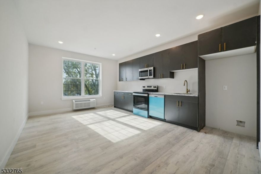 Welcome to 227 North Walnut, a newly constructed 5-floor residential building in East Orange, NJ, blending timeless charm with contemporary living. Discover spacious, modern living in this unique studio loft with 1 bath, designed for style and comfort. Large windows flood the space with natural light, creating a warm and inviting ambiance. The first level features a sleek kitchen equipped with stainless steel appliances and ample cabinet space,an open-plan living area ideal for a cozy seating arrangement and dining nook, and a large bathroom with contemporary finishes. Travel upstairs to the loft area, perfectly sized for a bedroom, providing access to your private roof deck perfect for entertaining. Residents at 227 North Walnut enjoy access to premium amenities, including a fully equipped fitness center, and a welcoming community room.Safety is a priority with a 24/7 surveillance system and a secure package room. Located just 5 minutes from BrickChurch Station,this unit offers a quick 30-minute commute to NYC. Steps from Sussex Plaza, you'll have dining, shopping, and essentials nearby.The area is also close to parks and green spaces, ideal for outdoor activities, and has easy access to I-280 and the Garden State Parkway. Photos are of similar unit.Parking available for additional cost