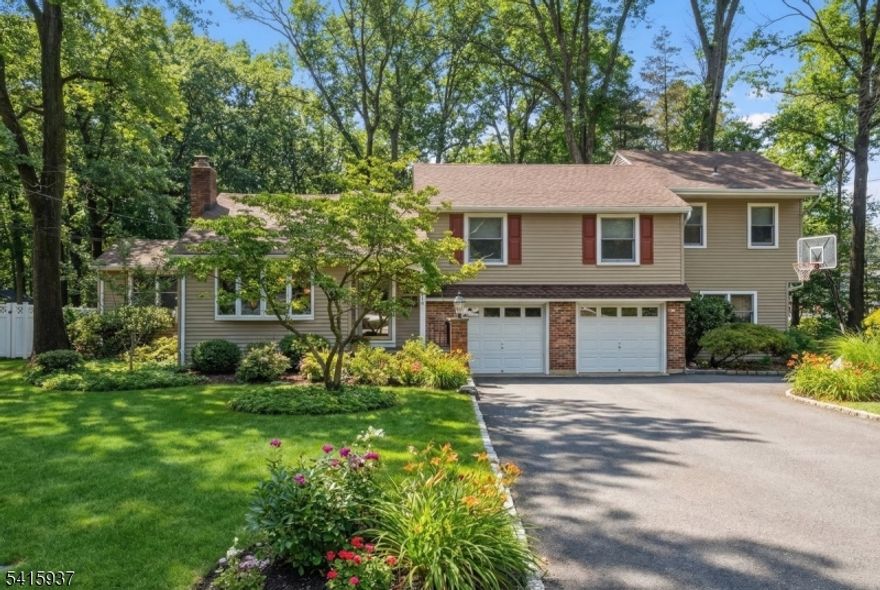 Welcome home to this beautiful 4 bed/4 bath home that has been updated to perfection for today's lifestyle with an elegant and spacious floor plan ideal for entertaining. Step inside to discover a meticulous interior featuring spacious living areas, gleaming hardwood floors and an abundance of natural light. The living room with gas FP flows perfectly into the formal dining room, ideal for hosting gatherings. The gourmet eat in kitchen has a large center island, stainless appliances, natural wood custom cabinetry and a timeless backsplash making it a chef's dream. The spacious family room just off the kitchen provides the perfect space to relax and overlooks the large tranquil backyard (over a half acre!) A convenient large home office/bonus room completes the first floor. The upper level offers four bedrooms including two en-suites. The luxurious primary suite is a peaceful retreat with ample closets and a private spa-like bathroom with a beautiful glass stall shower. There is a two car attached garage and an unfinished lower level storage room.  Step outside to the stunning private backyard oasis, where a professionally landscaped yard and gorgeous oversized trex deck sets the stage for incredible outdoor entertaining. Additional amenities include an irrigation system, a generator hookup and gas fireplace.  Located on a prime street in a wonderful neighborhood with easy access to top rated schools, parks, shopping and NYC transportation, this home is truly one of a kind!