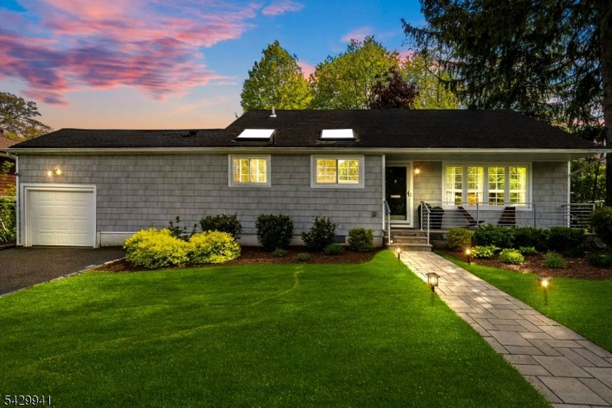 Tucked into Montclair's sought-after South End, this home offers the kind of quiet, settled feel that's hard to find. It features 3brm, 2.5bth & sits on a nearly quarter-acre lot, where three skylights and generous windows bathe the home in natural light from morning through evening. The kitchen anchors the main level with a quartzite waterfall island, stainless appliances, and white shaker cabinets, all beneath a vaulted, skylit ceiling that makes the space feel effortlessly open. A private home office just off the kitchen offers its own skylit retreat. A linear gas fireplace, hardwood floors, smart home controls, & a beautifully finished powder room carry the warmth through the rest of the main level. Upstairs, 3 bdrm & a full bth offer comfortable, well-proportioned living. The lower level is where the home truly opens up. A finished, multifunctional space that works as hard as you need it to, whether that's a 2nd home office, a gym, a media rm, or all three at once. A wine fridge, full bth, & a dedicated laundry round out a level designed for real life, with direct access to the backyard when the day calls for it. the yard has mature canopy trees, lush garden beds, a stone patio, and a wide open lawn create a private, park-like setting that feels genuinely removed ? rare at this price in Montclair's South End.Nishuane School and Nishuane Park are nearby. NYC transportation is close at hand. Downtown Montclair is easily within reach.