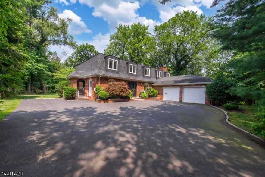 A Must See! Welcome to this spacious Mansard Colonial tucked away on a private .71-acre lot in Montclair Heights, Clifton's most sought-after neighborhood. offering over 4,000 sq ft of living space, this home combines timeless elegance with modern comfort. A dramatic two-story foyer invites you in. Large formal dining room is perfect for entertaining. The adjoining living room opens to a covered patio through French doors, creating seamless indoor/outdoor living. An oversized family room features a wood-burning fireplace, service bar, and additional patio access. The eat-in kitchen offers granite counters, a center island, breakfast bar, pantry, and a convenient side entrance from the driveway to easily bring in groceries. A private first-floor bedroom with ensuite bath is ideal for guests or extended living. Upstairs, a versatile open area leads to a spacious primary suite with multiple closets, gas fireplace, and a spa-like marble bath with skylight, soaking tub, stall shower, and double vanity. Three additional bedrooms share a Jack-and-Jill bath. A lower-level recreation room and an attached two-car garage complete this exceptional home. Close to Montclair town center, highways, public transportation and schools.