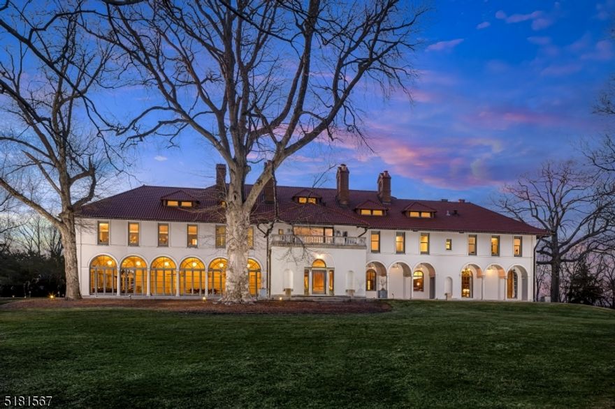 Inspired by Tuscany's distinctive country villas, the elaborate Faircourt mansion set on approximately 13 acres in Bernardsville has been restored to reflect both its former glory and its future aspirations. Its expansive layout provides seven bedrooms, eight full baths, two half baths, including a two bedroom, two bath guest suite. Each of the home's four levels are served by an elevator. 21st century comforts include a brand new kitchen with Boffi cabinets imported from Italy, Gaggenau appliances and radiant-heated floors; a new gas fireplace, and LED lighting accented the bookcases and fireplace in the family room; a quartz wet bar and dressing room in the primary suite; and radiant heated floors and new glass shower doors in the baths.Other unique design features of Faircourt include Bronze-accented wrought iron work in the entry opening to a foyer and 60-foot long gallery, a glass-enclosed loggia featuring marble and granite floor, a trophy room centered by a stone fireplace, an oak-paneled library lined in built-in bookcases imported from France, a walnut-paneled living room edged in gold leaf-accented moldings. For an estate of this size, there are corresponding amenities such as a VersaCourt tennis court, heated saltwater pool, putting green, heated parking courtyard, an orchard with peach, pear, apple and cherry trees. Upper and lower garages provide protected parking for multiple vehicles. Serving the property is a Savant Smart home automation and security system.