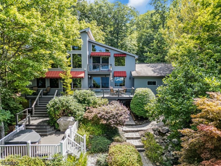 Welcome to 25 Lake End Rd, Green Pond, NJExperience the allure of lakeside living in this 3/4 bedroom, 4 bathroom home, perfectly located just a short stroll from the  village of Green Pond. This exceptional residence boasts 23' floor-to-ceiling windows in the great room, providing breathtaking panoramic views of the tranquil lake and lush surroundings. The open floor plan ensures a seamless flow between living spaces, enhanced by elegant hardwood floors throughout.On the first floor, you'll find a versatile study with an ensuite bath, offering the option to serve as a first-floor primary suite.The second floor features two generously sized ensuite bedrooms and a cozy sitting area with a deck overlooking the lake, perfect for enjoying serene sunsets.The lower level is designed for relaxation and entertainment, featuring a recreation room complete with a sauna and two wet bars, ideal for unwinding after a day on the water. The home is equipped with a full-house generator, ensuring comfort and convenience throughout the year.Additional highlights include an oversized attached two-car attached garage with an epoxy floor, a spacious yard with a hot tub, a koi pond, and a private dock perfect for embracing peaceful lakefront living.Located in the golf cart-friendly, private lake & club community of Green Pond,