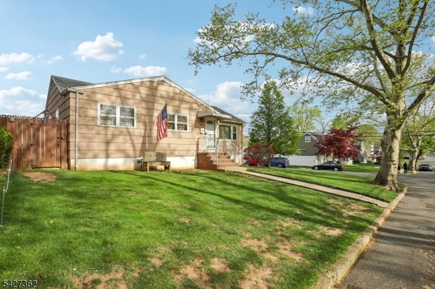 Do not miss this exceptional opportunity to make this charming ranch your own. Ideally located in the highly sought-after Inman Heights section of Rahway on a beautiful tree lined neighborhood, this home sits on a spacious corner lot with a fully fenced yard and an attached garage. Inside, you'll find hardwood floors throughout, three bedrooms, a formal dining room, and a welcoming living room, all offering a functional layout. The expansive basement with direct walkout access to the backyard provides incredible flexibility for additional living space, recreation, or storage. Thoughtfully maintained, the home features a brand-new water heater (December 2025) and a newer HVAC system (2017), along with central air conditioning and forced air heating for year-round comfort. Conveniently located just minutes from major highways, schools, shopping centers, and everyday amenities, this property combines location, space, and long-term potential in one inviting package.