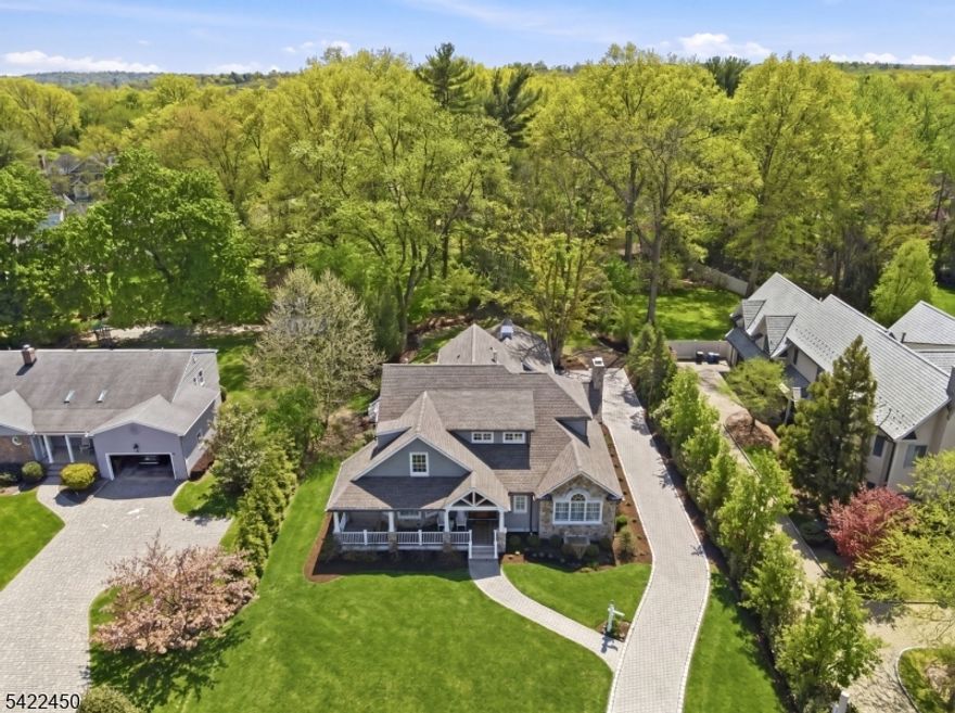 Experience effortless luxury in this stunning home built in 2023. A perfect blend of thoughtful design and exceptional top of the line finishings, this stunning residence with 9 foot ceilings offers 4 bedrooms, 4 full baths, and 1 half bath. The first floor primary suite is a true retreat, featuring dual walk in closets and a spa inspired bath with double vanities, soaking tub, and shower creating a serene escape. At the heart of the home is the chef's kitchen with gas fireplace, quartz countertops, dual wall Wolf ovens, Wolf 6 burner cook top, 48" Sub-Zero fridge  wine cooler, Miele dishwasher, fridge drawers and walk in pantry. This kitchen seamlessly flows into the breakfast room and family room with a gas fireplace perfect for both intimate gatherings and entertaining. This main level designed for convenience and ease also offers a living room with fireplace, office, mudroom, laundry room, powder room and an elevator for effortless access between floors. Upstairs, three generously sized bedrooms and two well appointed baths provide comfortable accommodations. The expansive lower level offers a full bath and endless possibilities for recreation, fitness, or additional living space. Set on .49 private acres, the outdoor space is equally appealing with a welcoming front porch, spacious deck, and lovely curb appeal. Also a three car heated garage, heated driveway, plenty of storage, cedar closet, 3 fireplaces, security system and so much more.  Enjoy this impeccable home!