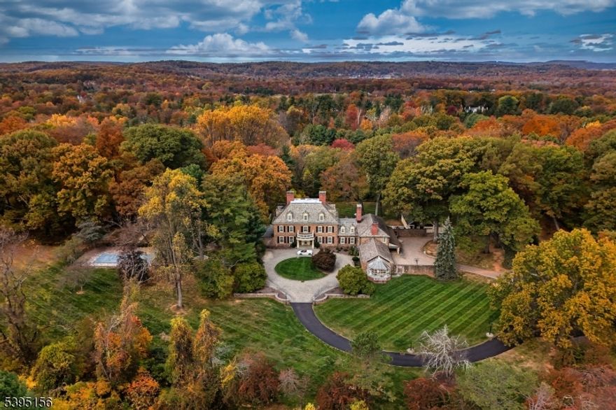 This extraordinary estate sits on approximately 6+ private acres and offers over 13,000 square feet of refined living space. The main level welcomes you with an impressive foyer featuring a 3-story grand staircase. A gourmet eat-in kitchen features stainless steel appliances, a large walk-in pantry, and direct access to outdoor sitting areas. The formal dining room is perfect for hosting intimate dinners or grand gatherings alike. A warm and cozy sitting room with a large wood-burning fireplace provides a relaxing retreat, while the family room offers a comfortable space for lounging or movie night. An incredible office with its own fireplace exudes timeless character, and a grand formal living room, complete with another fireplace, creates an impressive backdrop for entertaining. A second office with an additional powder room provides flexible space for work or study. The primary suite spans the entire left wing of the home. The bedroom features its own fireplace, dual walk-in closets, and a spa-inspired bathroom with double vanities, an expansive shower, and a soaking tub positioned beside a fireplace for ultimate relaxation. Four additional en suite bedrooms, a gym, and a laundry room complete this level. The upper level hosts two additional en suite bedrooms and a generous storage area, maintaining the home's sense of comfort and scale. A resort-style pool sits beside the cabana, which includes a full bathroom, kitchen, recreation area, and storage.