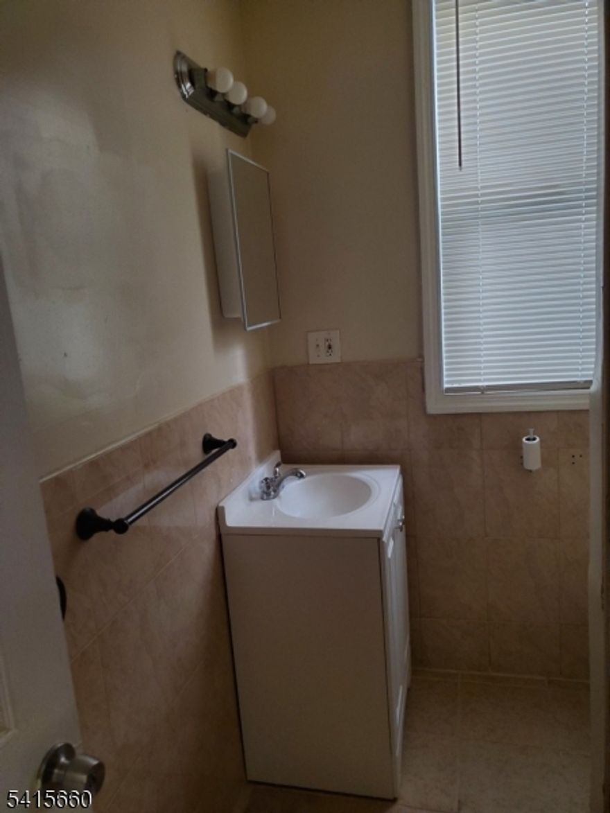 This meticulously maintained first-floor residence offers the perfect blend of urban convenience and modern comfort in the heart of Newark's Upper Clinton Hill. This spacious three-bedroom unit features an open, sun-drenched living area that flows into a dedicated dining space and a kitchen with ample cabinetry. All three bedrooms are generously sized with large windows and sufficient closet space, with the primary bedroom easily accommodating a full bedroom set. A commuter's dream, this home is located steps from NJ Transit bus lines with direct links to Newark Penn Station, the PATH, and Amtrak, while offering easy access to I-78 and the Garden State Parkway. Residents will enjoy being walking distance to local schools, West Side Park, and various neighborhood shopping and dining options. This unit represents a premier opportunity for high-quality living.