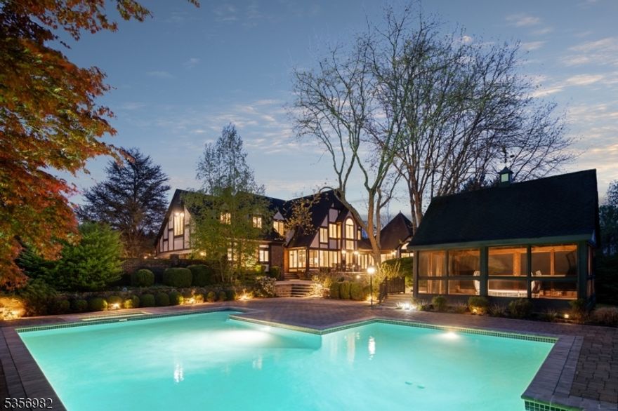 Nestled on five sprawling, lush acres, this enchanting Tudor-style estate harmoniously integrates classic elements with sleek, modern finishes. Set amidst meticulously landscaped grounds, the property offers ultimate privacy and tranquility, featuring serene gardens, multiple entertainment patios, and a sparkling pool. The detached, screened-in porch and three-car garage with expansive unfinished space above provide endless possibilities for relaxation and future customization. Step inside to discover a home designed for both comfort and style. The breathtaking family room, with its inviting open layout, flows seamlessly onto the rear patios, creating a perfect space for indoor-outdoor living. Large glass windows offer spectacular views of the private grounds, while the incredible living room captivates with its vaulted ceilings, floor-to-ceiling windows, and a majestic two-story stone fireplace. The recently renovated kitchen is a chef's dream, featuring top-of-the-line finishes and modern conveniences. A sun-drenched conservatory offers a serene spot to unwind and enjoy the beauty of the outdoors year-round. The finished lower level with a second kitchen and bath, adds even more versatility, ideal for a home theater, gym or recreation room. Whether you're hosting guests or relaxing in solitude, this estate offers a truly special lifestyle in sought after Mendham Borough- just moments away from award winning schools, fine dining and shopping, NJ Transit and major highways.