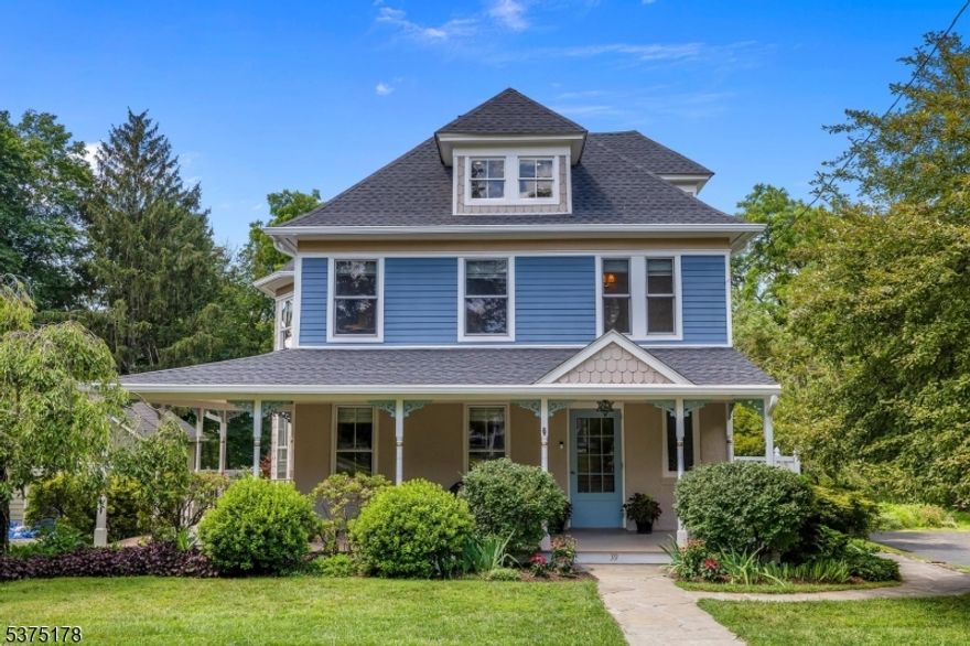 This grand American Foursquare home in Peapack Gladstone is a showpiece of timeless beauty and modern livability. Surrounded by breathtaking, meticulously curated gardens bursting with seasonal color, the home invites you to linger on its iconic wraparound porch or unwind on the sweeping two-tier deck with views of nature at its finest. Inside, a graceful foyer opens to an airy living room and an elegant dining space where a marble-framed fireplace sets the tone for memorable gatherings. The first floor also features a private guest suite with full bath. Upstairs, the primary suite offers a spa-like bath with walk-in shower and custom built-ins, complemented by an exposed-brick hallway leading to three additional bedrooms, two now used as offices and a gorgeous custom full bath. A third-floor hideaway provides endless possibilities a media lounge, music sanctuary, or reading escape. A custom home with authentic period windows, dual heating and cooling, and a brand-new roof complete this rare find, just steps from NYC train service, renowned eateries, and the countryside charm of Ninety Acres.