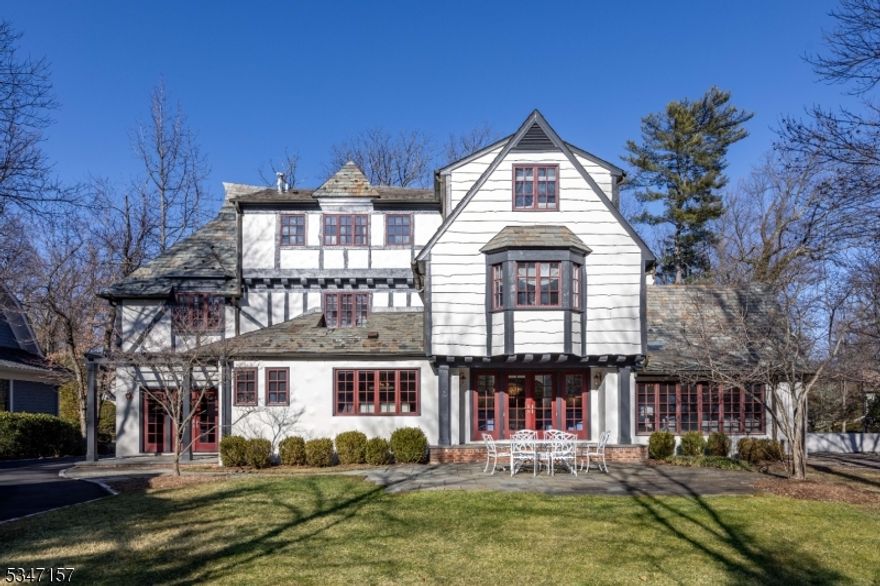 This exquisite residence that epitomizes perfection in every detail harmoniously blends the finest modern amenities with architectural charm. Filled with large windows, many of which are stained glass, this home invites sunlight all day long. The large living spaces are a testament to superior craftsmanship and make the space perfect for entertaining. Featuring intricate handcrafted woodwork and refined finishes throughout, the home captures the essence of a storied past. The gourmet kitchen is a chef's dream, equipped with top-of-the-line appliances and ample space for culinary endeavors. For those who appreciate leisure and entertainment, the home offers a private movie screening room, perfect for enjoying cinematic experiences. Wine connoisseurs will delight in the custom-designed wine cellar, ideal for showcasing and preserving a treasured collection. The expansive layout boasts five beautifully appointed bedrooms and four full and three half luxurious bathrooms, each offering a unique blend of style and comfort. The primary suite is a sanctuary of relaxation with thoughtful design elements that enhance its timeless appeal. The property itself is a beautifully landscaped oasis, offering serene outdoor spaces that are both inviting and private. Whether hosting gatherings or enjoying quiet moments, this setting provides the perfect backdrop. An easy stroll to downtown Millburn and steps to NYC train from either station, this location is perfection.