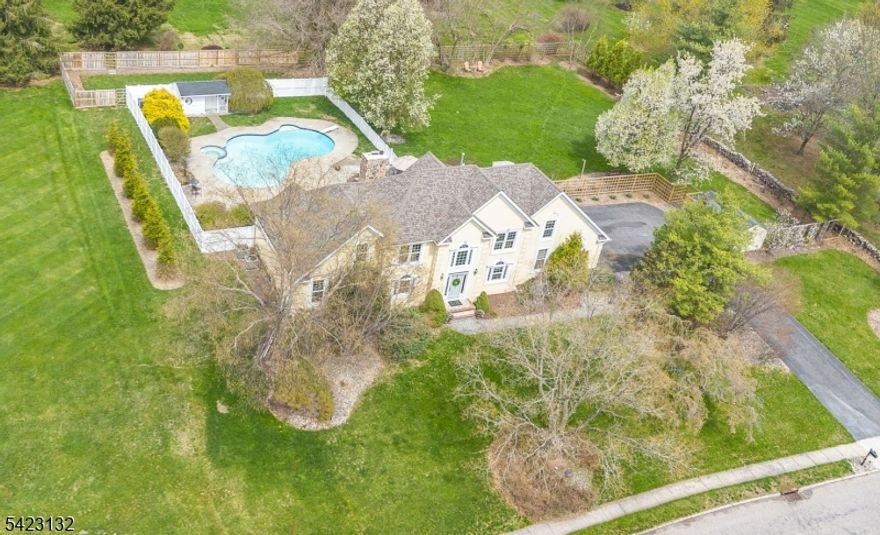 Resort style pool & yard make this custom center hall colonial the perfect summer 2026 destination. The 2 story foyer greets you & your guests with French doors on both sides elevating the formal living room & dining room/ currently being used as a home office and TV room. The Great Room offers views to the backyard oasis, a large brick fireplace & vaulted ceilings adding character & depth. Washed maple cabinets compliment the granite countertops in this center island kitchen with vaulted ceiling dining area & second staircase. The door to the deck is right next to the 2nd powder room & laundry for your convenience. On the other side of the home another powder room & first floor Primary Bedroom suite with oversized bathroom including jacuzzi tub overlooking the pool. Upstairs you will find 3 generous bedrooms, a full bathroom & an oversized bonus room currently used as a bedroom. The basement is full of potential with bathroom plumbing for toilet & shower & several framed out rooms, plenty of storage and open space. The yard offers even more potential with property behind the fenced in pool area and a large fenced in yard big enough for all the fun & gardening you can imagine. Roof (2024), Chimney (2024), custom wood fencing (2024), shed roofs (2023), Energy Efficient Furnace, both units (2022), Energy Efficient AC, both units (2022), hot water heater (2022), front windows & water softener (2016). Close to shopping