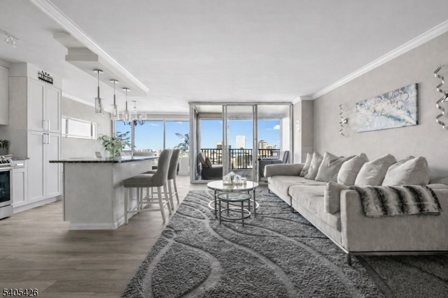 This exceptional 2 br, 2 bth residence offers a rare split-bedroom layout and has undergone a complete, top-to-bottom renovation. Located within Fort Lee's Horizon House co-op, the home delivers a refined blend of modern design, comfort, and panoramic scenery. The interior has been fully transformed with premium finishes and meticulous attention to detail. A redesigned open-concept kitchen anchors the home, featuring a large center island, custom cabinetry, quartz countertops, and a Samsung black stainless appliance package with fingerprint-resistant surfaces. Both bathrooms have been beautifully renovated with sophisticated tile selections and contemporary fixtures. Additional upgrades include smooth skim-coated ceilings, crown molding, new interior doors, custom closet systems, and tailored window treatments throughout. Floor-to-ceiling windows capture sweeping views of the George Washington Bridge, the Hudson River, and the Ramapo Mountains. An indoor garage parking space transfers with the apartment. Total monthly fees of $3,119 include maintenance, parking, capital assessment, cable, internet, all utilities, real estate taxes, and the building's underlying mortgage. Co-op guidelines require an approximate gross annual income of $117,000 with no debt. Conveniently positioned near public transportation, shopping, dining, and major highways, with quick access to New York City, this home offers a rare combination of full renovation, iconic views, and exceptional convenience.