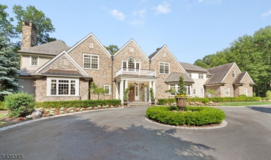 Absolutely stunning stone front Manor House perfectly embodies the joy of graceful living with 9,125 sq. ft. of commodious living space on the two upper floors, plus the added luxury of a sprawling, magnificently finished 2,800 sq. ft. lower level with walkout, & 23.7 private woodland acres with tax-saving State Forestry plan pending.  Sited at the very end of a quiet cul-de-sac in a coveted Roxiticus Valley neighborhood, with the added pedigree of a Far Hills mailing address.  21 rooms including 7 airy bedrooms with superb primary bedroom suite, 7 full baths, 3 powder rooms, 6 fireplaces, formal living room has radiant picture window with transoms, soaring great room with exposed beams, stacked windows, & wet bar, gorgeous gourmet designer kitchen replete with large center island with prep sink, premium appliances, & adjoining breakfast room ,well-appointed butler's pantry, tasteful dining room boasts stylish center chandelier & resplendent wall of windows, handsome library with built-ins & convenient access to the 3-season porch, first-floor guest bedroom, outstanding mudroom area with built-in lockers/cubbies.  Volume coffered & tray ceilings, custom millworker & lighting, radiant heat, & lustrous hardwood flooring throughout- this outstanding home has a heated 4-car attached garage with  EV charging station.  Completely private showcase property with sprinkler system, night accent lighting, & back-up generator. Top-rated Mendham Twp schools & commuter-friendly location.