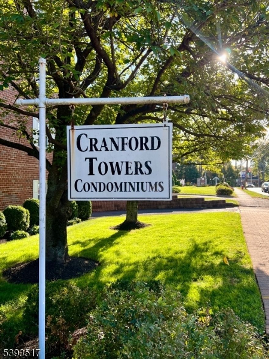 Location " Location " Location! Step right into the heart of downtown Cranford and enjoy everything this vibrant town has to offer! This beautiful, move-in-ready condo in the highly sought-after Cranford Towers offers generous room sizes and an unbeatable setting just steps from NYC trains, buses, restaurants, coffee shops, the movie theater,  parks, and so much more. Located on the third floor of an elevator building, this bright and airy unit overlooks charming downtown Cranford. The spacious two-bedroom, one-bath layout features wood floors throughout, a kitchen with plenty of cabinet space, and a separate eating area off the kitchen or a living room/dining area combination perfect for entertaining. The bathroom includes a stall shower, and there's ample closet space throughout the unit. Enjoy added convenience with secure intercom access for guests and deliveries, a large welcoming lobby, clean and bright laundry facilities with washer, dryer, and folding table, plus extra assigned secure storage in the basement. The unit also includes a tandem assigned garage space (shared with neighbor) with a garage door opener. Pets permitted with board approval. The monthly HOA fee (593.20) includes heat, hot water, natural gas for cooking, trash and snow removal, and common area maintenance.