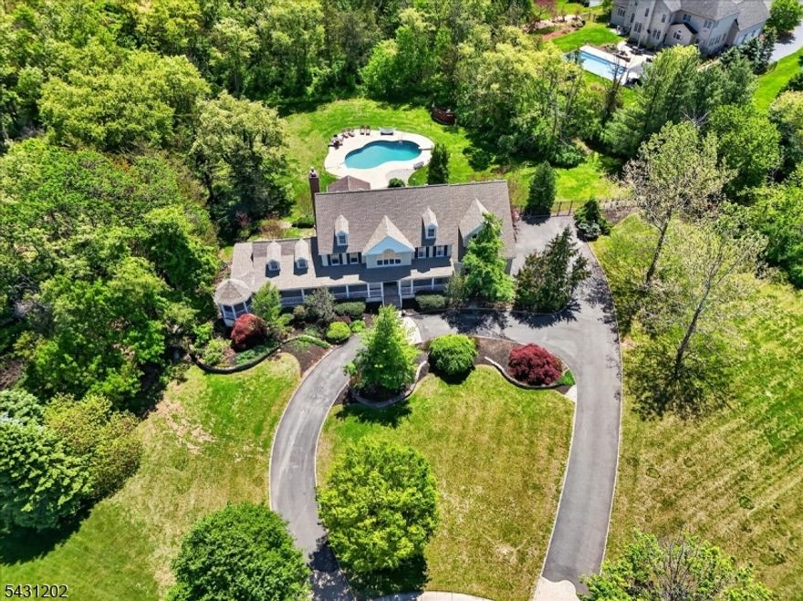 Situated at the end of a peaceful cul-de-sac in desirable Hillsborough Township, this exceptional estate-style home offers the perfect blend of privacy, elegance, and everyday comfort. Set on over 3 beautifully landscaped acres, the property features a circular driveway, wraparound front porch with swinging bench and gazebo, and a backyard oasis designed for entertaining with a heated saltwater pool, covered deck, expansive bluestone patio, and lush landscaping. Inside, a dramatic two-story foyer welcomes you into the spacious and light-filled interior. The formal dining room is perfect for hosting, while the elegant living room flows into a sun-drenched Florida room with vaulted ceilings,  and access to the porch and gazebo. The generously sized eat-in kitchen features a center island, stainless steel appliances, and abundant dining space, opening to a warm family room with a wood-burning fireplace. The main level includes a bonus room ideal for an office, a spacious laundry/mudroom with rear yard access, oversized powder room, and attached two-car garage. Upstairs, the luxurious primary suite offers three walk-in closets and an en-suite bath with soaking tub, double vanity, and walk-in shower. Three additional generously sized bedrooms and a well-appointed hall bath complete the second level. The finished basement adds incredible flexibility with recreation, fitness, media space, full bath, and ample storage. Convenient to Routes 287, 202, and the Somerville train station.