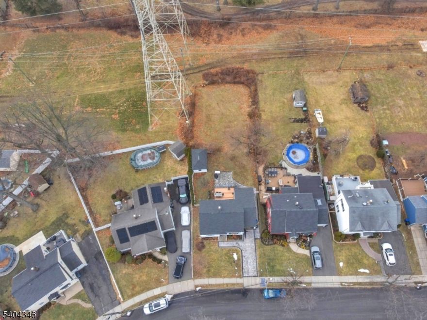 Welcome to this beautifully maintained ranch home, perfect for moving in immediately! This residence boasts several upgrades completed over the past few years, including a new roof, newly paved driveway, and updated central heating and air conditioning.Enjoy the warmth of hardwood flooring throughout the home. The full basement offers endless possibilities for various uses. The sunroom off the kitchen is currently being utilized as a bedroom but can easily be converted back to its original purpose or transformed into a dining room.Step outside to a spacious backyard featuring a lovely deck that overlooks the golf course ideal for relaxation and entertaining.This home is conveniently located near schools, major highways, and transportation to NYC. Don't miss the opportunity to make this charming ranch your own!