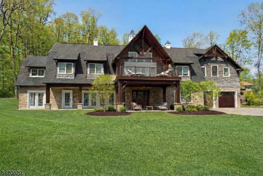 ABSOLUTELY MAGNIFICENT CRAFTSMAN-STYLE CUSTOM HOME INSPIRED BY THE GRAND ESTATES OF THE LATE 19TH CENTURY AND THE DESIGN TRADITION OF ARCHITECT ROBERT A.M. STERN. DRAMATIC GABLES, OVERSIZED WINDOWS, CEDAR SHINGLE SIDING AND NEW CEDAR FRONT PORCH CREATE THIS STUNNING EXTERIOR. A FULL ROOM-TO-ROOM RENOVATION IN 2015 PRESENTS THE HOME IN LIKE-NEW CONDITION. OFFERING 12 ROOMS, THE LAYOUT INCLUDES 4 BEDROOMS, 4 FULL BATHS AND 1 POWDER ROOM. ENJOY A SPACIOUS FAMILY ROOM PLUS A LIVING ROOM THAT CAN ALSO SERVE AS A DEN. A FLEXIBLE ADDITIONAL ROOM NEAR A FULL BATH IS IDEAL FOR A HOME OFFICE, GUEST SUITE. THE HAND BUILT DESIGNER KITCHEN FEATURES A FIREPLACE AND OVER 250 SQ FT OF GRANITE COUNTERTOPS, CUSTOM BUILT CABINETRY A BUTLER'S PANTRY, AND SEAMLESS FLOW TO A STUNNING DINING ROOM. HARDWOOD FLOORS THROUGHOUT; RADIANT HEAT ON THE SECOND FLOOR. THE PRIMARY SUITE IS A SHOWSTOPPER WITH A PRIVATE FRONT BALCONY AND SITTING AREA. CUSTOM BUILT-INS AND EXQUISITE TRIM AND MOLDINGS ARE FOUND THROUGHOUT. NEARLY 5,000 SQ FT SPANS TWO LEVELS, PLUS A 1,400 SQ FT LOFT AREA READY TO BE FINISHED. ADDITIONAL HIGHLIGHTS INCLUDE CUSTOM BUILT CEDAR FRONT UPPER LEVEL DECK AND LOWER PATIO AREA, A BRAND NEW DRIVEWAY LEADS TO OVERSIZED 4-CAR GARAGE, EXPANSIVE REAR PATIO AND OUTDOOR KITCHEN SET ON A PRIVATE 3.25-ACRE PROPERTY WITH PLENTY OF ROOM FOR A POOL.