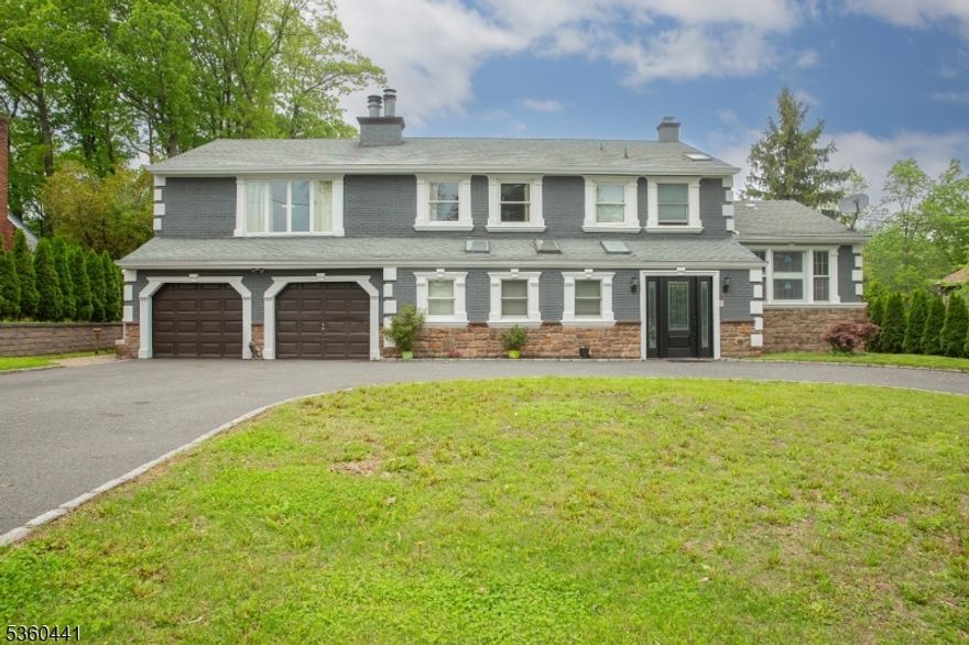 A Truly Distinctive Home, this stunning Colonial is nestled in a sought-after location w/effortless access to Rt 80, 46, & a variety of shopping including Costco, Walmart, local malls, movie theaters, and restaurants. This stately 4-bedroom, 2.5-bath colonial boasts tremendous curb appeal with its eye-catching fa ade, accented by custom decorative stonework, crisp white cornices, and classic black trim. A grand wrap-around circular driveway offers a dramatic 1st impression. Step inside & you'll find a sprawling layout. Oversized Master Suite features a generous square footage & layout that provides endless options for creating a tranquil sanctuary. The home features not 1, but 2 striking fireplaces, including a floor-to-ceiling natural stone fireplace in the main LR and a corner stone fireplace in the MB. Enjoy multiple skylights throughout the home that bathe the interior in sunshine, creating a warm & airy ambiance. The gourmet kitchen showcases rich custom cabinetry, gleaming granite countertops, stainless steel appliances, a center island w/built-in cooktop, & a charming tray ceiling w/decorative tile inlay. Beautifully updated bathrooms w/stylish tile work, sleek vanities, & elegant finishes, including a spa-like main bath w/skylight, step-up tub, and sliding glass enclosure. Step out back to a generous custom wood deck and serene koi pond with waterfall.