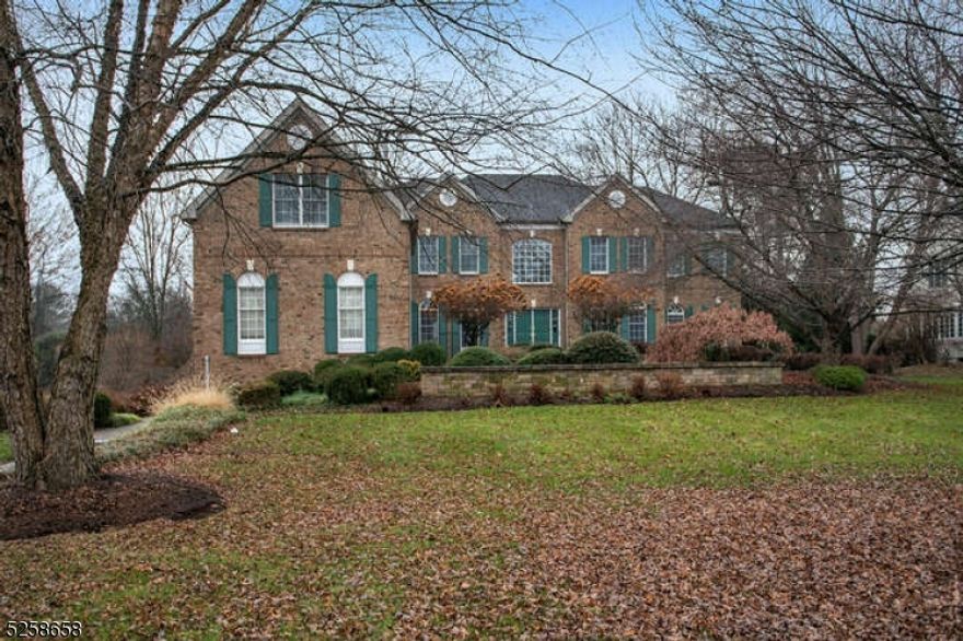 First-class luxury meets everyday comfort in this stunning custom 6-bedroom colonial set on an idyllic 1.5 private acres. Each space is outfitted to impress, from the graceful staircase in the foyer to the elegant dining room with tray ceiling and custom moldings. The brand-new custom kitchen boasts high end quartz countertops, Zellige tile backsplash, top of the line Thermadore appliances, Shaw sink, undercabinet lighting and custom wet bar with beverage fridge. The breakfast area leads to the sunroom with views of the expansive property and door to the backyard and paved patio. The two-story family room features a brick gas fireplace and coffered ceiling. Completing this level are the living room, office with custom built-in cabinetry, bedroom with en-suite bath, powder room and laundry room. The second level has a magnificent primary suite with bonus sitting room/office, custom fitted closets, and luxurious spa-like bathroom with heated floors. There are four additional bedrooms, two with en-suite baths and two share a Jack and Jill bath. The lower level offers endless possibilities as a rec room or gym with a walk-out entrance to the breathtaking rear yard. This gem has new hardwood flooring on the second floor and in the family room, refinished hardwood on the first floor, is newly painted and has a Generac whole house generator. Close to shopping, parks, restaurants, and transportation in a top NJ school district, this is the exceptional home you've been waiting for!