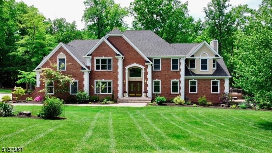 Beautifully situated on a quiet cul-de-sac, this impressive Colonial in the upscale Winding Ridge neighborhood is certain to draw attention.  Through loving care and thoughtful upgrades, this turn-key home remains fresh and modern. As sunlight pours in through large windows, the versatile interior welcomes any decor. Recently renovated basement adds 1800 sq ft of living space. You will be thrilled with the updated, gourmet kitchen with top of the line Cambria Quartz counters and backsplash, while the open-concept floor plan is made for effortless entertaining and daily living. The first floor also includes a wood-paneled home office, an in-law suite, and a light-filled sunroom, perfect for enjoying the beauty of the manicured landscape. Bedrooms are spread across all three levels, offering restful sleep for every generation, and each bathroom has been updated to today's style. The master is spacious and luxurious, with a generous walk-in closet and an en suite bathroom with a relaxing jetted soaking tub. The recently finished walk-out basement is stunning and adds an exercise room, full bathroom, entertainer's kitchen and family room to this gracious home. Outside, the multi-level deck easily supports dining and entertaining, while the nearly two acre property is beautifully landscaped and private. The outdoor space also includes a multi-use sports court, perfect for your favorite outdoor activities.