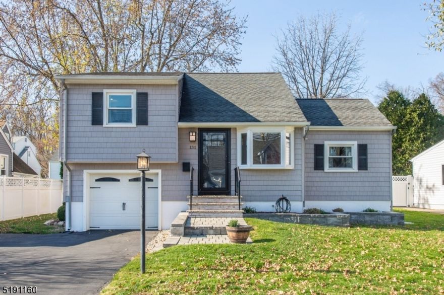 Welcome to this Stunning Three Bedroom Split Level in the desirable Lake Parsippany area.  Picture perfect curb appeal is just the beginning. Beautifully updated throughout  from the new (2022) custom Craftsman Front Door entry to the spacious Living Room;  Eat In Kitchen with 36" extensive cabinetry, Carrera Quartz countertops, stainless steel appliances.   First floor bedroom (currently separated by non weight bearing wall) used as guest room and separate office.  Upper level features Master Bedroom and additional bedroom with full, updated bath.  Lower level offers spacious Laundry Room with utility sink - potential powder room location.   Newer roof, siding, and windows.  Gas in street if buyer wishes to convert.  Crown molding throughout.  Private oasis rear yard with new paver patio (September 2022); expansive deck for entertainment, hardwired weatherproof outdoor speakers.  Oak Hardwood flooring - only one bedroom and office carpeted.  Pull down attic stairs - easy access and large storage area.   A wonderful community and lifestyle not to be missed! Membership to Lake Parsippany $135 annually.