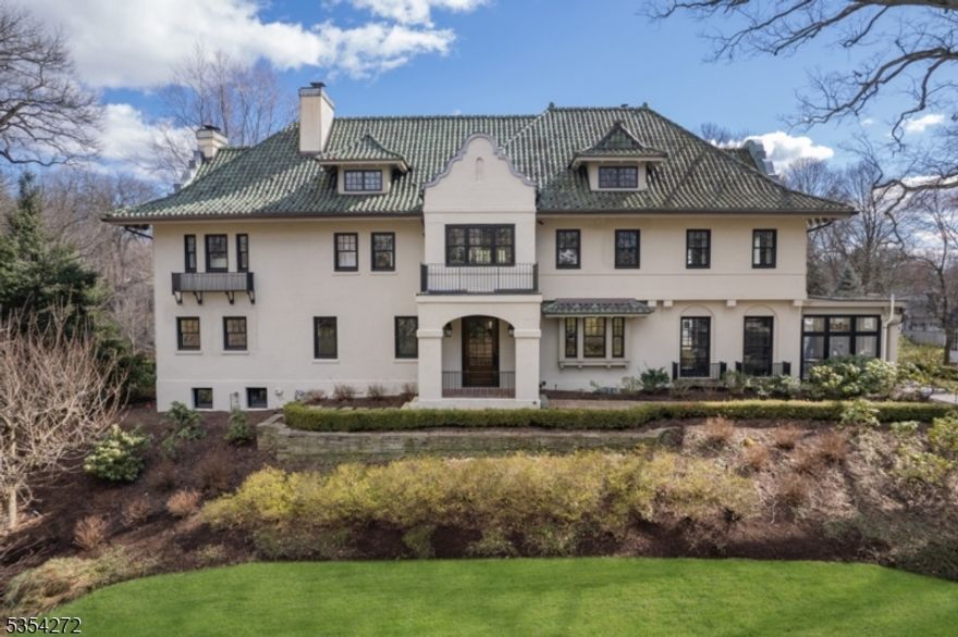 Spectacular Summit Northside Mission Style Colonial, built circa 1916. A whole house renovation and addition in 2013, done by Rosen Kelly Conway Architectural & Design and built by Orchard Hills, was featured in the Northern New Jersey City Guide. This beautiful 7 bedroom home also boasts 7 fireplaces, 4 gas and 3 woodburning. A grand reception hall and foyer with original wrought iron staircase welcome you into the 7,402 square foot home. The home features hardwood floors and magnificent walnut wood trim throughout, pocket doors, and high ceilings with barreled ceiling detail. The carriage house includes an exercise room, yoga studio, full bath and two-car heated garage. The house is located on .86 acre of professionally landscaped grounds created by DePhillips Landscape Design and located just 0.6 mile to downtown Summit, shopping, schools, and Midtown Direct train service to New York City.