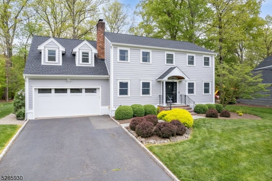 TURN KEY CHARMING CENTER HALL COLONIAL WITH TREMENDOUS UPGRADES IN COVETED CHATHAM TOWNSHIP! Presenting 36 Mitchell, a 5 Bedroom, 3.1 Bathroom gem, nestled on a delightfully quiet street, and just minutes from Blue Ribbon Elementary, excellent dining, shopping, parks, and more! You will fall in love with the upscale finishes, gorgeous updated hardwood floors, and great flow throughout the entire home. Welcoming bright Entry Foyer with handsome wainscot paneling. Sun-drenched Chef's Kitchen is spaciously satisfying with granite countertops, custom wood cabinetry, vaulted ceiling with skylights, enhanced Jenn-Air stainless appliances, large center island, and awesome views of the Backyard. Elegant Living Room with marble/gas fireplace, and lovely Dining Room with chair rail molding. Cozy Den with natural light off Kitchen. Marvelous Mudroom with custom cubbies. Primary En-Suite Bedroom stands-out with brand new built-in floor-to-ceiling dresser, window seats with storage, and freshly crafted, large walk-in closet with custom shelving. 4 additional Bedrooms, including generous En-Suite Bedroom with Full Bath, all boast tons of light and ample closets. Lower Level Recreation Room with wood-like tile floor ideal for working-out, gaming, and/or home office  plus GREAT storage. Enjoy entertaining outdoors on the two-tiered stone patio with fire pit and luscious level yard, privately backed by woods and the Great Swamp.