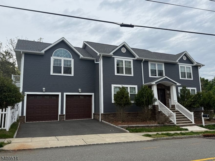 Welcome to this custom Colonial offering over 3,500 sq ft of living space and situated on a desirable corner lot in the heart of town. This home features an open floor plan with a spacious Living room w/fireplace and directly flows into the Dining room that opens to the Modern Eat-in kitchen with quartz countertops and large center island. Convenient Powder room completes the first level. Second floor offers a large Master Bedroom with sliders to a private balcony overlooking the backyard, a walk-in closet, and Master Bath with jetted tub, along with four additional Bedrooms, Laundry room, and full Bathroom. The fully finished Basement provides a spacious Family room and plenty of space for a Rec room, Playroom, Office, or home Gym. Additional highlights include multi-zone heating, central air, large fenced yard with private picuzzi that is just perfect for entertaining, and two-car attached Garage with additional driveway parking. Prime location close to parks, schools, shopping, dining, major highways, and NYC transportation.