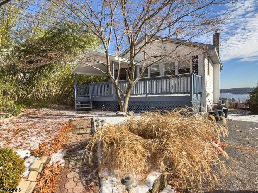 H & B BY THURSDAY 12/18 BY 5 PM.   Bring you vision to this fantastic Lake Hopatcong opportunity!  This 2 bedroom - 2 bath home offers an open floor plan, a cozy fireplace, an EI kitchen, and a spacious deck with BEAUTIFUL views of the Lake Hopatcong - the perfect backdrop for year-round enjoyment.  Lots of windows provide abundance of natural light.  The property needs work, making it an ideal fit for anyone looking to build sweat equity, as well as investors or contractors seeking their next project.  There is an optional beach membership at Crescent Cove close by. Home is strictly sold AS IS,  Septic is believed to be original. Buyer responsible for all inspections and certifications.  Fireplace in "as in" condition - has not been used in years.