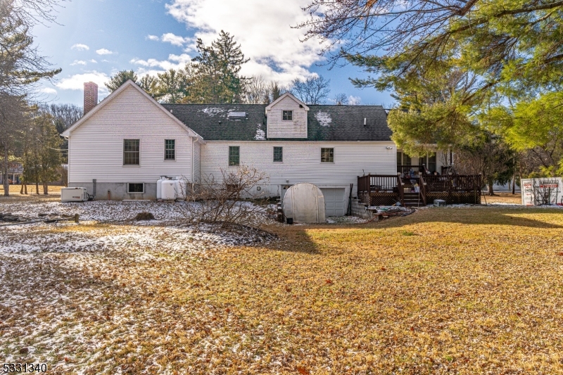 Welcome to this charming Expanded Ranch in a peaceful Lebanon Township neighborhood, set on 2.47 acres. The inviting family room and dining room feature a stunning chandelier, with the dining room conveniently near the eat-in kitchen and access to a deck. The first floor boasts 3 spacious bedrooms with hardwood floors, plus an additional room suitable for a library or office. Upstairs, you'll find another bedroom and a cozy sitting room. The private deck is perfect for quiet evenings. The basement includes a laundry area, workshop, recreation room, and ample storage with garage access. With a fairly new water heater and furnace, this home is both functional and efficient.Located on Sliker Road, it's close to shopping, dining, and commuter Route 513, proximity to Voorhees State Park, the Columbia Trail, and Memorial Park, with the highly rated Voorhees School.