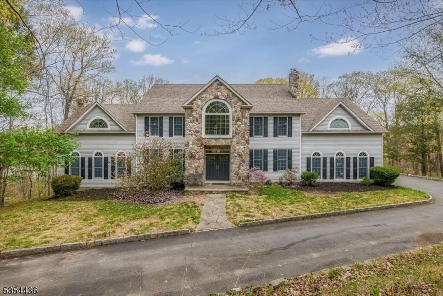 Beautiful oversized colonial and spacious estate in the desired Sunset Lakes community. This home features a gorgeous kitchen that is highlighted by granite counter tops, a large center island with ample storage, stainless steel appliances and sliders to the deck. Then step down to the great room with 30ft vaulted ceilings, a stone fireplace and French doors leading to the massive deck overlooking the property line and Sunset Lake! Once you walk through the double doors to foyer you are greeting by a stunning staircase welcoming 4 bedrooms upstairs. The primary suite entails an oversized sitting room, sleeping areas, two closets and a luxury bath with a jetted tub. The ground level hosts an optional in-law suite with 5th bedroom and full bath, full bar area, viewing room, utility room and storage which also walks out with French doors. The property is lake front, private and secluded.*4 bedroom septic*
