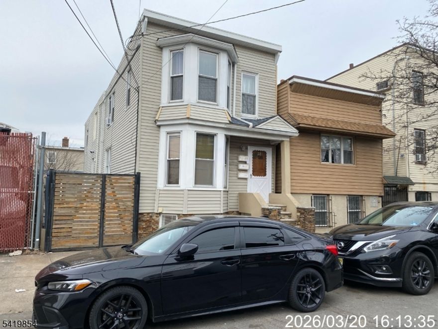 Investment opportunity in a prime Ironbound location. Sold "As Is.  Unique layout offers a front multi-family plus a separate rear single-family perfect for maximizing income, flexibility, and long-term value. Front Unit 1 (1st floor + lower level) lives like an expanded residence: 1 bedroom, living room, eat-in kitchen, full bath, plus 4 additional bedrooms and a second full bath below: Central A/C, forced-air heat, updated water heaters, and laundry hookup (tenant-owned). Unit 2 (2nd floor) features 2 bedrooms, an eat-in kitchen, a full bath, laminate/ceramic flooring, gas heat, window A/C, updated plumbing, and a newer water heater. Tenant pays electric and 40% gas. The rear home is ideal for owner-occupancy or premium rent: open-concept living, half bath, and modern kitchen with stainless steel appliances. The second floor offers 2 bedrooms, skylights, and a full bath. Hardwood floors, central A/C/heat, and tankless water heater. Covered outdoor area adds lifestyle appeal. Additional highlights include a fenced yard with gated access and a storage shed. Walk to Newark Penn Station (NYC-25 min), near major highways, Newark Airport, top dining, shopping, and a fast-growing business district.