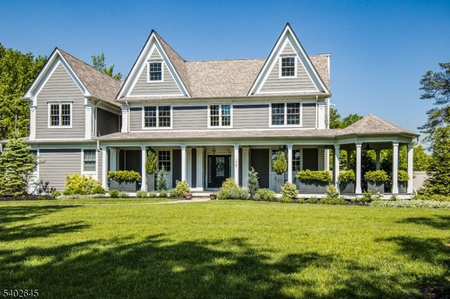 Welcome to this spectacular, meticulously maintained custom home set on over an acre of flat land. A covered front porch w/ rotunda leads into a grand two-story foyer showcasing gleaming hardwood floors, custom millwork, and elegant formal living & dining rooms w/coffered ceilings. The chef's kitchen features granite countertops, SS appliances, a center island with custom cabinetry, & a wet bar with beverage center. Open to the family room, sliding doors lead to a fully fenced backyard complete w/ a covered patio, bluestone walkway, hot tub, & wood-burning fireplace perfect for indoor-outdoor entertaining. The first floor also offers an in-law suite with full bath, powder room, & a mudroom. The second level boasts a luxurious primary suite w/ custom walk-in closet, sitting room w fireplace, and spa-like bath featuring an oversized stall shower and jetted tub. Three generously sized bedrooms, two full bathrooms, and a walk-in laundry room w/ beverage center complete this level. The third floor offers a private bedroom w/ full bath, home office, & ample storage space. The finished lower level is an entertainer's dream, featuring a full eat-in kitchen w/ granite countertops, oversized bar, microwave, dishwasher, beverage center, full-size refrigerator & freezer, plus a spacious recreation room w/ fireplace, sauna, and full bath w/ steam shower. Experience four finished levels of impeccable design, seamlessly blending modern sophistication with timeless elegance in every detail!