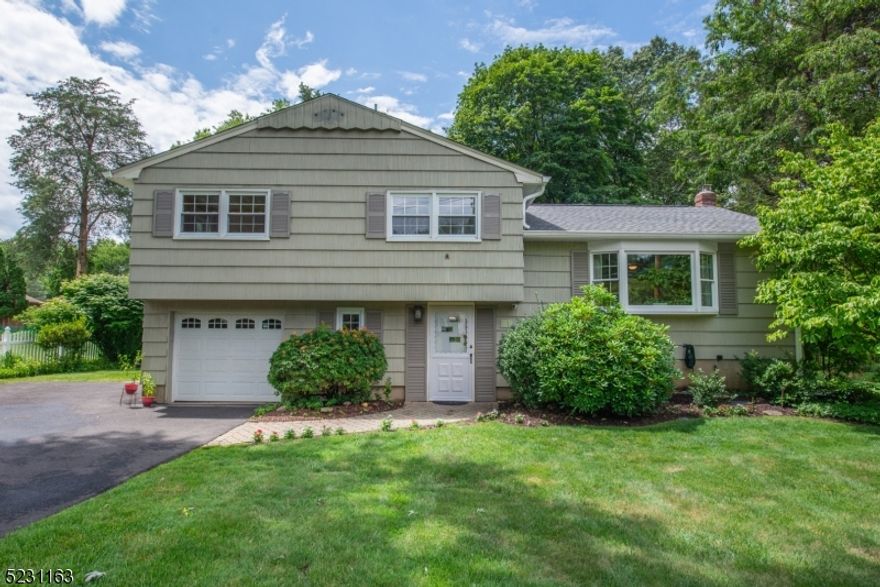 Modernized spacious split with bonus sunroom set on 1/2 acre, across from Muriel Hepner Park and Rock Ridge Lake!  Foyer leads to cozy family room with freestanding gas wood stove and sliders to patio to enjoy the privacy of the shaded backyard.  Kitchen, dining and living rooms with hardwood flooring and 4 season sunroom brings the outdoors in.  Upper level offers 3 spacious bedrooms, including primary suite with full bath and walk-in closet.  Join the lake for a nominal fee and participate in all the activities it offers including dinners on the beach, swim club, campouts, food truck festivals, etc.  Public utilities, newer roof, newer central air, insulated attic, 2 year young water heater, freshly painted.  Not to miss this price point to enter the Denville community and all the conveniences and amenities it offers!