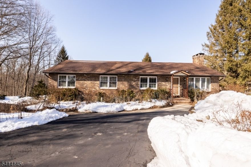 Welcome to effortless one-floor living set on a beautiful 1-acre lot, offering space, comfort, mature gardens and versatility. This 4-bedroom ranch features 3 full bathrooms and a thoughtfully designed layout ideal for both everyday living and entertaining. Step inside to a formal living room and dining room featuring a large wood burning fireplace, accented by hardwood floors throughout, creating a warm and timeless atmosphere. The beautifully updated eat-in kitchen is a true centerpiece, offering abundant cabinet space and functionality for home chefs and gatherings alike. Just off the main living area, you'll find a large heated sunroom, perfect for relaxing year-round while enjoying views of the surrounding property.Convenience is key with laundry and an additional refrigerator located on the main level, making single-level living a breeze. The home also includes a partial home back-up generator for added peace of mind. Down stairs, the finished basement expands your living space with a spacious family room, den, kitchenette, and storage closet, ideal for entertaining or flexible work-from-home needs. Car enthusiasts and hobbyists will appreciate the 3-car garage, providing ample storage and workspace.Important Details: Home is being sold as-is, Verified 3-bedroom septic system, Hydraulic load test completed February 2026, with no repairs required. This well-maintained ranch offers comfort, space, and opportunity, all in a serene setting.