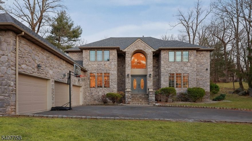 Nestled on a quiet cul-de-sac and set on a private wooded lot, this elegant Colonial home boasts a striking stone exterior and timeless curb appeal.  A dramatic two-story foyer opens gracefully to the second floor, creating a bright and welcoming entrance.  Hardwood floor runs throughout the home, adding warmth and elegance to every room.  The spacious living room offers a walkout to a private patio, perfect for relaxing outdoors or entertaining while enjoying the peaceful wooded surroundings.  The thoughtfully designed layout features a desirable first-floor primary suite, complete with a spacious walk-in closet and a private full bath for ultimate comfort and convenience. The remodeled bathrooms feature updated fixtures, contemporary finishes, and a fresh modern feel. The second floor offers three additional generously sized bedrooms, provides ample space for guests or home office. The home is also equipped with a whole-house generator, offering dependable backup power and ensuring comfort and functionality even during unexpected outages.