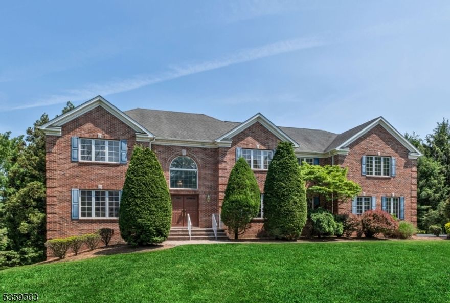 Stately brick colonial nestled on a quiet cul-de-sac, offering an exceptional floor plan. A grand two-story entry leads to a banquet sized dining room, formal living room & a sunken great room with soaring ceilings, skylights & a woodburning fireplace. The spacious eat-in kitchen features a large center island, high end appliances & a slider to the newer Trex deck, perfect for entertaining. A large 1st floor office or den, laundry/mudroom, powder room & access to the 3 car garage adds to everyday convenience. Upstairs you'll find 5 generous bedrooms, including a primary suite with 2 custom walk-in closets and a junior ensuite with tray ceiling. The finished walk-out lower level includes a large rec room, full bath and possible 6th bedroom. Beautifully manicured property in a fantastic location with access to top rated schools, parks, shopping, transportation & more!