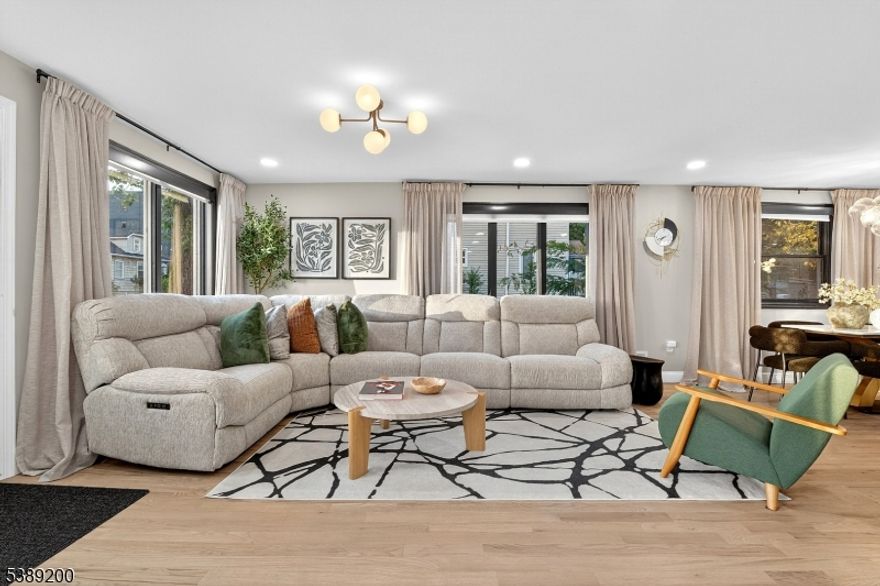 Prime location with easy access to public transportation and a vibrant downtown filled with shopping and restaurants! This stunning Colonial was fully upgraded in 2022 with modern finishes and timeless style. Featuring 4 bedrooms, 4 full bathrooms, and a beautifully finished basement, this home offers space, comfort, and flexibility. The open-concept main level showcases luxury vinyl flooring and recessed lighting, flowing into a chef's kitchen with a center island/breakfast bar, 42" shaker cabinets with crown molding and gold hardware, subway tile backsplash, undermount sink, and premium stainless steel appliances including a French-door refrigerator, 5-burner gas range with vent fan, microwave drawer, and dishwasher. Sliding doors lead to a deck for effortless indoor-outdoor entertaining, plus a full first-floor bath with tiled stall shower. Upstairs includes 4 spacious bedrooms and 2 full baths, including a primary suite with a spa-like custom-tiled bath. The finished basement offers a large rec space, full bath, and laundry room with custom shelving. Fully fenced backyard oasis with deck, paver walkways, and an in-ground pool with waterfall and diving board. Dual-zone HVAC and beautiful lighting throughout. Close to NYC bus, trains, and major roadways: 287, 1&9, GSP, NJTPK.