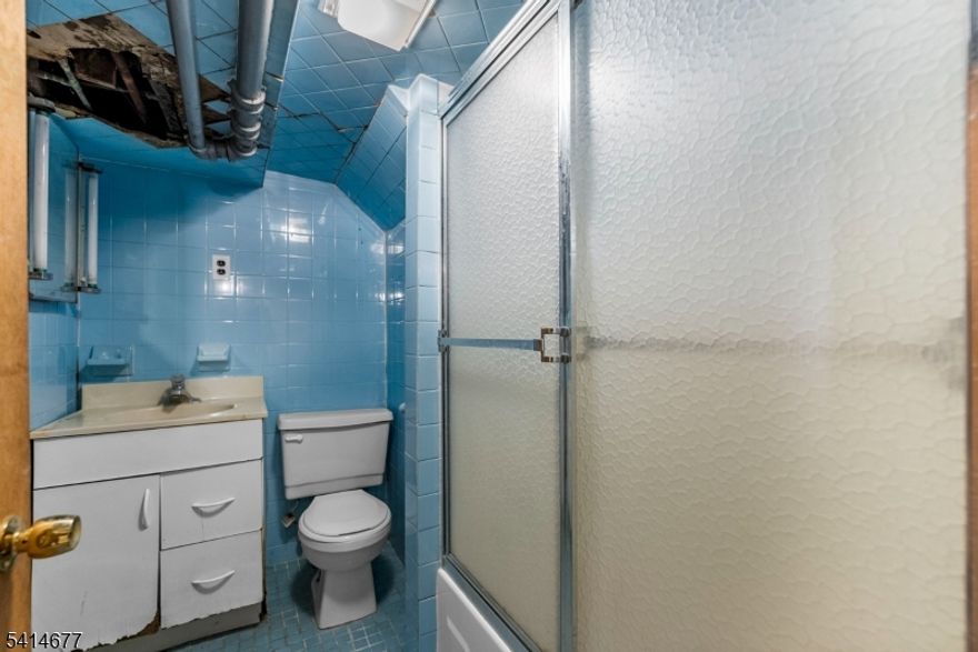 3-Story Two-Family with Bonus Attic Space, Walkout Basement & Off-Street ParkingThis spacious multi-family property offers strong income potential and flexible living across three levels. The home features two main units, each offering 3 bedrooms, 1 full bath, and 5 total rooms, creating comfortable layouts suited for tenants or owner-occupants. The third-floor attic level includes a finished bonus room, ideal for a home office, studio, or additional storage depending on a buyer's needs. A walkout basement provides extra storage and utility space, adding further versatility to the property. Outside, the home features exclusive off-street driveway parking wide enough for multiple vehicles, a valuable amenity in the area. Exterior details include classic clapboard siding and an asphalt shingle roof. Utilities include natural gas heating with steam radiators, a gas hot water heater, and public water and sewer service. The property currently does not have central air conditioning. Conveniently located in Paterson, the home offers easy access to local shops, restaurants, parks, and major commuter routes. Whether you're seeking a solid investment property or an opportunity to live in one unit while generating rental income from the other, this property presents excellent potential.