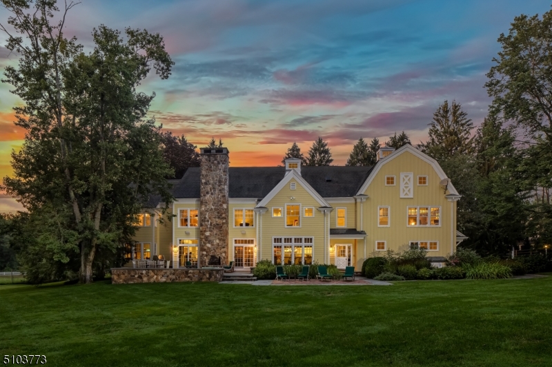 This tranquil estate offers unparalleled privacy within the heart of Harding Township.  A stunning custom home, 4-stall barn and a detached office suite are perfectly sited on 6.5 level, serene acres. Crafted of the finest materials, this light-filled home features intricate millwork, dark hardwood floors, bespoke fixtures and designer window treatments. The floor plan unfolds to encompass three finished floors and over 7600 square feet.  Some of the favorite gathering places are the pine-paneled library with coffered ceiling, the billiards room or relaxing in front of the fieldstone fireplace in the family room.  A first floor bedroom and adjacent full bath offer privacy for guests.  Four ensuite bedrooms, including a four-room primary suite, an office, playroom and laundry room complete the second floor.
