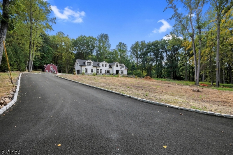 Stunning 5 BDRM on 2.1 acres of land in Chester New Jersey. Nestled on 2 picturesque acres, this beautifully renovated 5 BDRM colonial in Chester offers unmatched elegance & craftmanship. A paver walkway leads to the grand entrance where a bright foyer welcomes you into a sunlit living room. The spacious family room, anchored by a wood burning fireplace, opens to a gourmet kitchen with granite countertop & high-end finishes. Off the kitchen, you will find a mud room and access to the two car garage. A versatile room next to the family room can serve as an office, playroom or billiards room. A first floor master suite features a walk in closet & spa like bathroom. Upstairs, the second master BDRM includes an en-suite bathroom and walk in closet. Three additional bedrooms all with walk in closets, share a full bath. The upstairs landing provides extra space for an entertainment nook or library. A gravel driveway leads to a detached Barn, two stalls and an upstairs room perfect for an artist studio, office or playroom. The exceptional property offers luxury & charm, set in one of Morris county's top ratd school districts-a rare find for you and you won't want to miss.