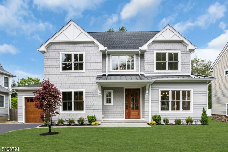Welcome to this architecturally detailed modern 2026 custom home built from the foundation up in Chatham's highly coveted Upper Washington Ave section. Blending thoughtful design with effortless daily living, this 6-bedroom, 5.1-bath residence features a flowing floor plan for relaxing and entertaining. A 2-story foyer creates a warm first impression, showcasing white oak flooring, rich millwork, cove molding, and coffered ceilings. The heart of the home is an expansive chef's kitchen with a quartz center island, prep sink, Wolf range, pot filler, walk-in pantry, and a sunlit breakfast room. This space opens seamlessly into a welcoming family room with a cozy gas fireplace. The main level also offers elegant formal living and dining rooms, a mudroom, and a flexible bedroom with a full ensuite bath. Upstairs, the primary suite is a peaceful retreat with a cathedral ceiling, cove lighting, wall-mounted bed lamps, a feature wall, custom walk-in closets, and a spa bath with dual vanities, glass shower, and soaking tub. Three additional bedrooms, two baths, laundry, and attic access complete the second floor. The finished lower level adds a large recreation room, utility room, and a sixth bedroom with a full ensuite bath. The property includes an oversized 1-car garage, new paver walkway and patio. Walk to top-rated schools, downtown shops, and the Midtown Direct train. A truly wonderful place to call home!